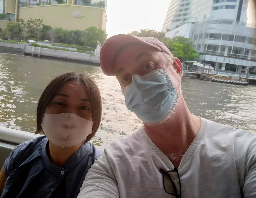 Sachie and I in masks on the boat during covid.