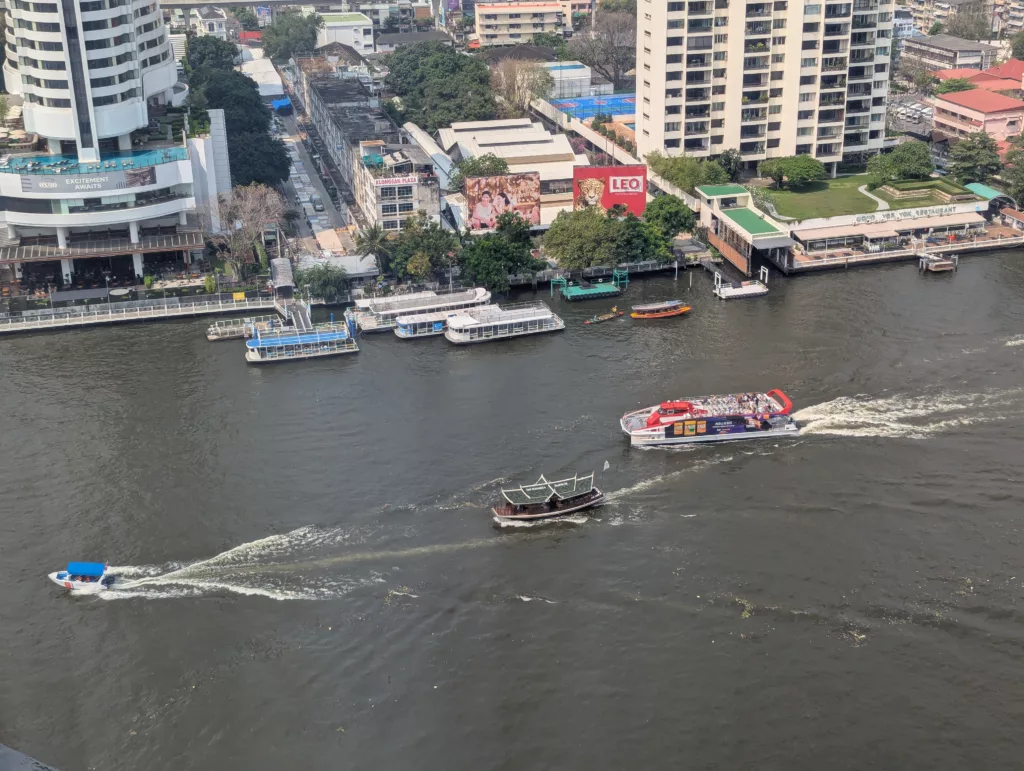 Boats making wakes on the river